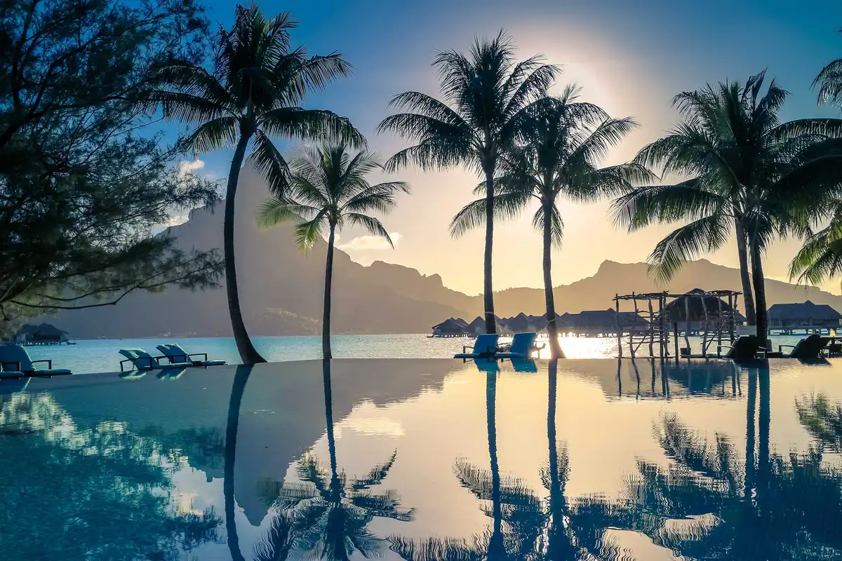 shutterstock_474249478_Sunset-in-Bora-Bora-French-Polynesia-.-Palm-trees-and-Mount-Otemanu-reflected-in-the-pool.-Retro-style-color-tones.jpg